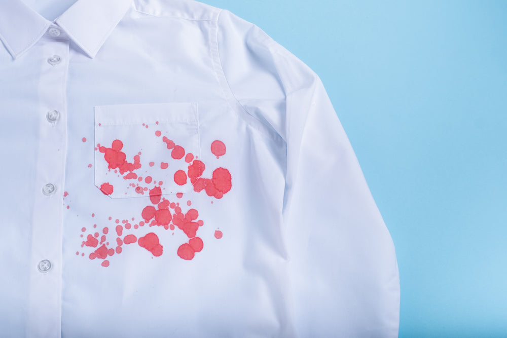 dirty blood stain on clothes. The concept of cleaning stains on